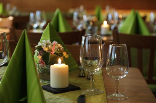 a table with a candle and wine glasses at VISPERBLICK 24-7 Parkplatz und Frühstück inkl in Ausserberg