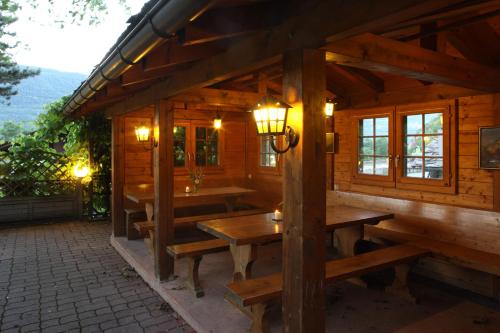 a wooden cabin with wooden tables and lights on it at VISPERBLICK 24-7 Parkplatz und Frühstück inkl in Ausserberg