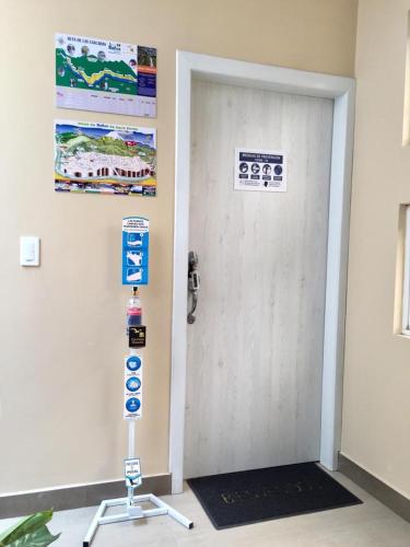 a white door in a room with a sign next to it at Casa Gaviota Dorada in Baños