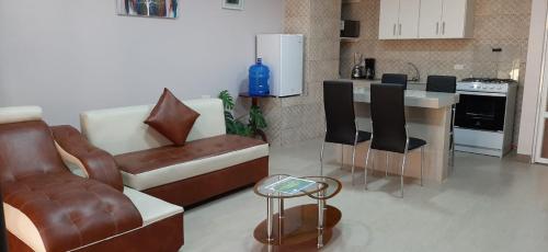 a living room with a couch and a kitchen at Casa Gaviota Dorada in Baños