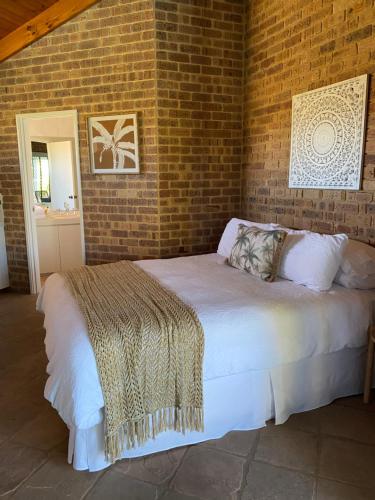 a bedroom with a white bed and white walls at Nautilus Retreat Kalbarri B&B in Kalbarri