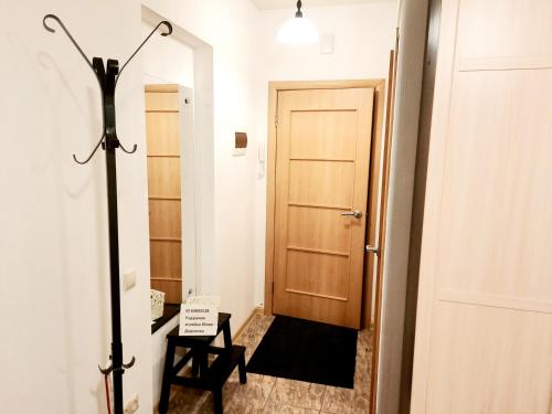 a hallway with a door and a chair and a lamp at flat-all 50 Plehanovskaya однокомнатная квартира в центре рядом ТРЦ Галерея Чижова до 4-х мест in Voronezh
