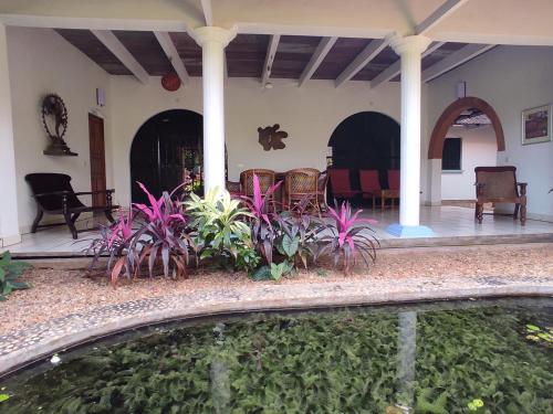 a house with a swimming pool in the yard at Gaia's Garden Guest House in Auroville
