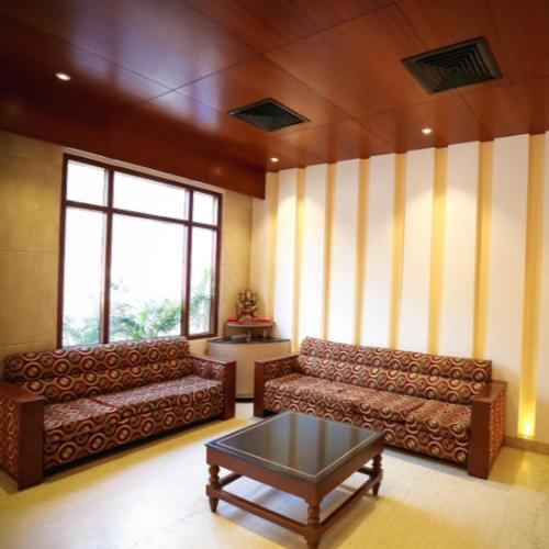 a living room with two couches and a coffee table at Regency Square Hotel in Gwalior