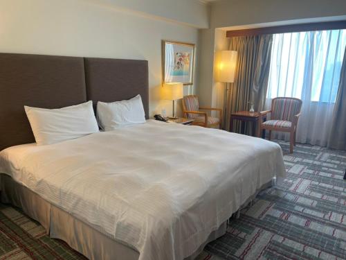 Postel nebo postele na pokoji v ubytování The Howard Plaza Hotel Kaohsiung