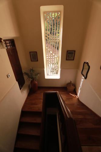 a stairway with a window and a stair case at Vanilla County in Vagamon