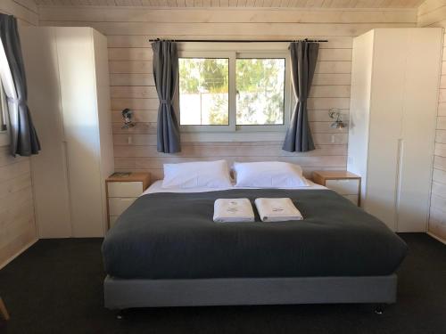 a bedroom with a bed with two books on it at Jenolan Holiday Park Oberon in Oberon