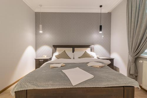 a bedroom with a large bed with two tables at Nikol in Turitsa