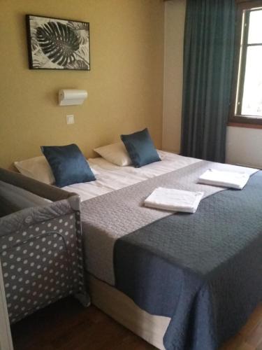 two beds in a hotel room with blue pillows at Saimaa Style Spa Chalet in Imatra