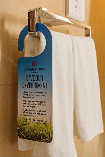 a sign on a towel rack with towels at Pride Elite, Phaltan in Phaltan