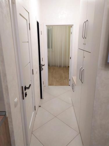 a hallway with white doors and a tile floor at Apartment Gagarinsky in Arcadia in Odesa