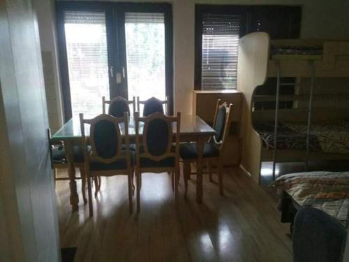 a dining room table and chairs in a room at Apartments Filemi in Ohrid