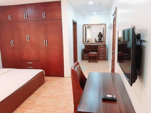 a bedroom with a bed and a table and a mirror at Somek Homes2 in Lekki