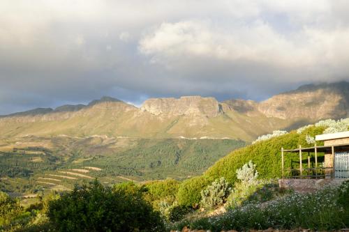 a view of a mountain range with a house at Amberg Country Estate in Paarl