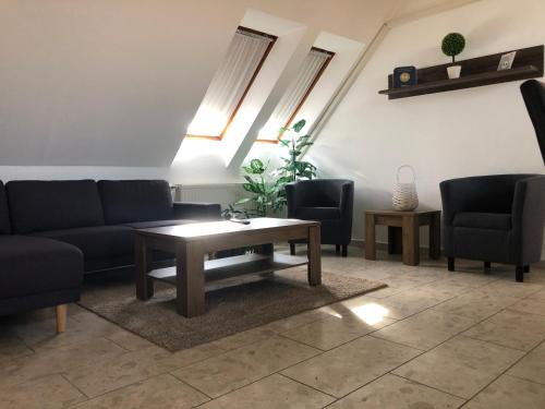 a living room with couches and a coffee table at Mol-Ker-Vill Apartment in Lenti