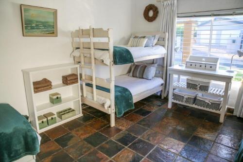 a room with two bunk beds and a window at Brander View in Hermanus