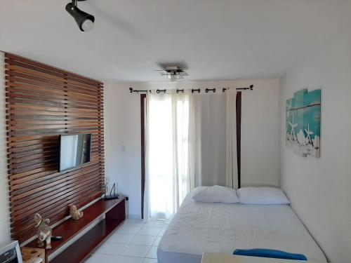 מיטה או מיטות בחדר ב-Flat Recanto dos Golfinhos