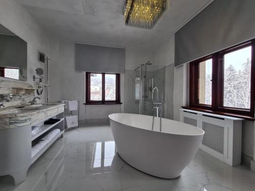 Duża biała łazienka z dużą wanną w obiekcie Rezydencja Biały Jar w mieście Karpacz