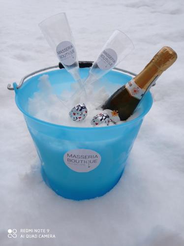 a bottle of champagne in a bucket of snow at Masseria boutique b&b in Montella
