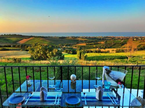 a view of the ocean from the balcony of a house at Live Your Dream in San Costanzo