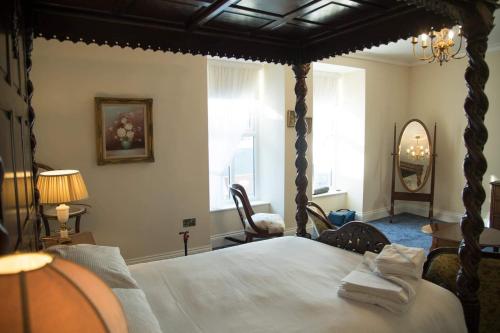 a bedroom with a large bed with a canopy at The Royal in Barmouth
