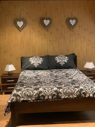 a bedroom with a bed with hearts on the wall at Agro na Wapniarni in Białla