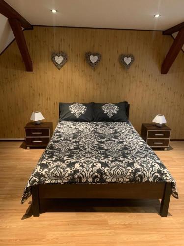 a bedroom with a bed with hearts on the wall at Agro na Wapniarni in Białla