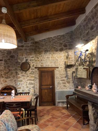 a dining room with a wooden table and a tableablish at Tenuta de Maffutiis in Polla