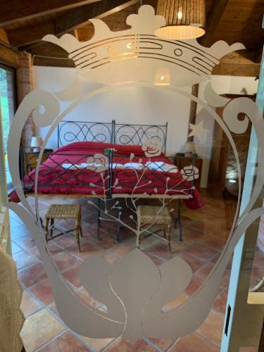 a bedroom with a red bed in a room at Tenuta de Maffutiis in Polla