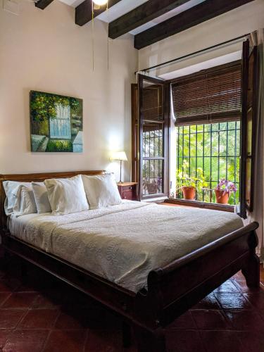 a bedroom with a large bed and a window at Hotel Fuente del Sol in Antequera