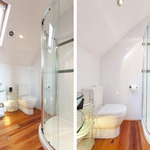 a bathroom with a toilet and a glass shower at Mews Cottage Bangor in Bangor