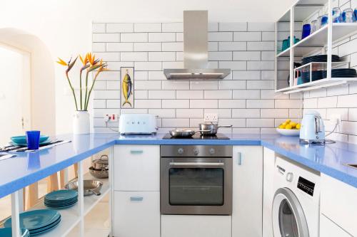 a kitchen with a blue counter top and a dishwasher at Zima Blue in Zygi