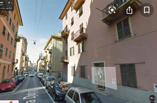 a city street with cars parked next to buildings at CASA IVO in Genoa