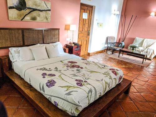 a bedroom with a large bed in a room at Hotel Fuente del Sol in Antequera