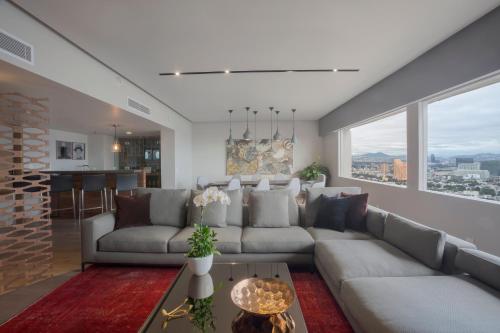a living room with a couch and a table at Presidente InterContinental Mexico City by IHG in Mexico City