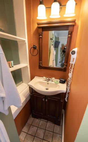 a bathroom with a sink and a mirror at Casablanca Inn on the Bay in Saint Augustine