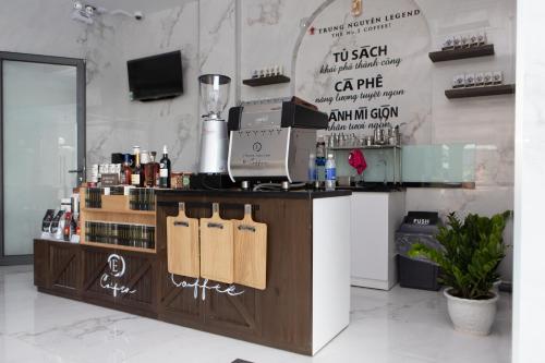 a bar in a room with a counter with bottles of wine at SUNRISE Hotel HA TIEN in Ha Tien