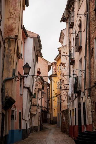 an alley in an old town with buildings at Moneda 46 in Cuenca