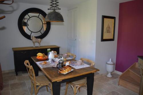 a dining room table with a tray of food on it at Le MAGNOLIA in La Croix-en-Touraine