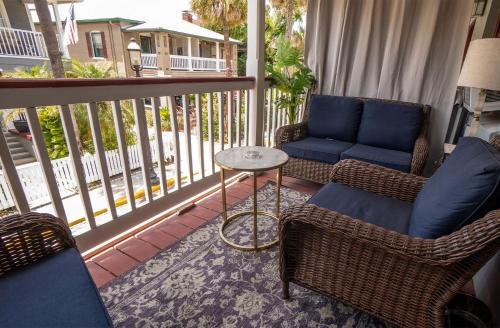 a porch with two chairs and a table on a balcony at Casablanca Inn on the Bay in Saint Augustine