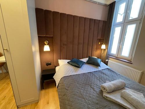 a bedroom with a large bed with two pillows on it at DK Premium Warmińska Secesja in Olsztyn