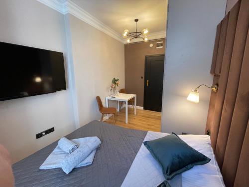 a bedroom with a bed with two towels on it at DK Premium Warmińska Secesja in Olsztyn