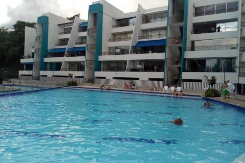 a swimming pool in front of a apartment building at Condominio vacacional Paraiso del Sol, San Jeronim in San Jerónimo