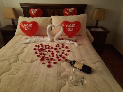 two swans made out of hearts on a bed at Apartahotel saquenzipá in Villa de Leyva