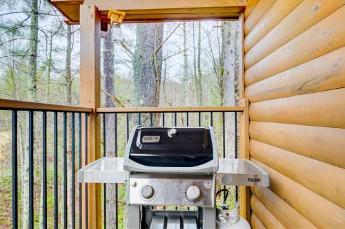 a screened in porch with a grill and a window at Deer Crossing in Sautee Nacoochee