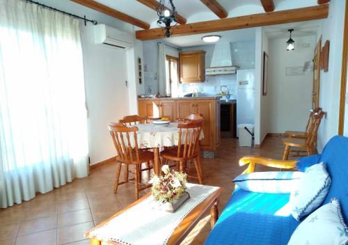 a living room with a table and a blue couch at La Casa del Carrebaix in Orba