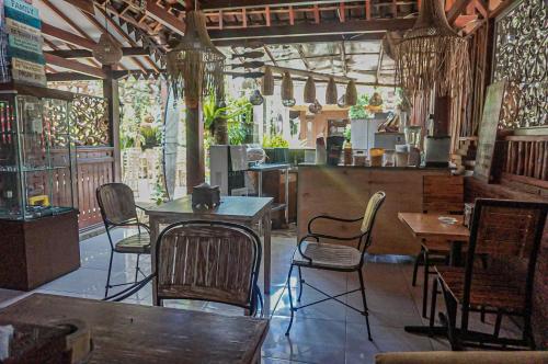 a restaurant with tables and chairs in a room at The Wisma Pulau Merah in Pasanggaran