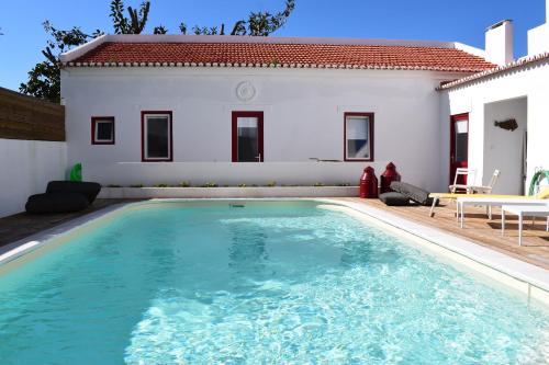 a swimming pool in front of a house at Sunny Studio 1 in Parede