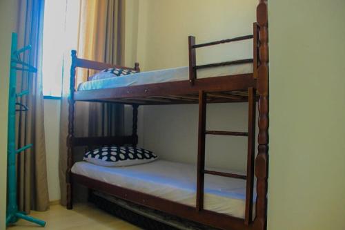 a couple of bunk beds in a room at Casa Rebello - Pousada in Itajaí