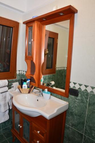 a bathroom with a sink and a mirror at VILLA DEI CICAS in Taranto